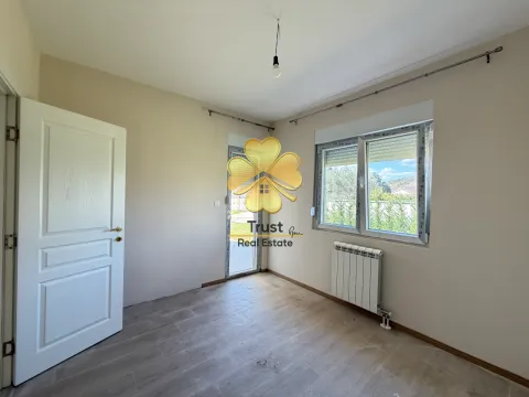 Empty room with a white door, window, and radiator. - image 12