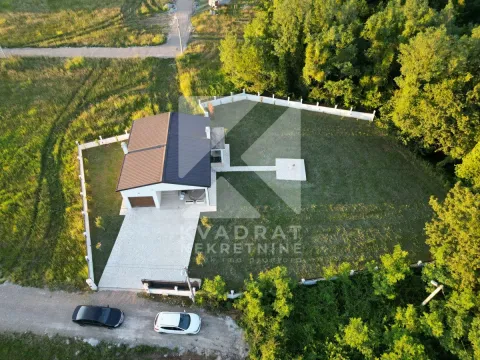 Aerial view of the house with a fenced yard and greenery. - image 4