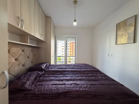 Bedroom with a double bed, fitted wardrobe, and a window. - image 11