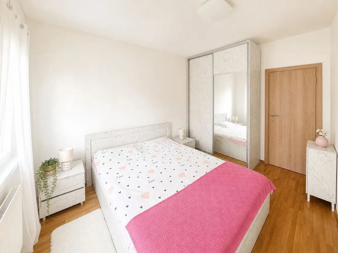 Furnished bedroom with a double bed, wardrobe, and nightstands.