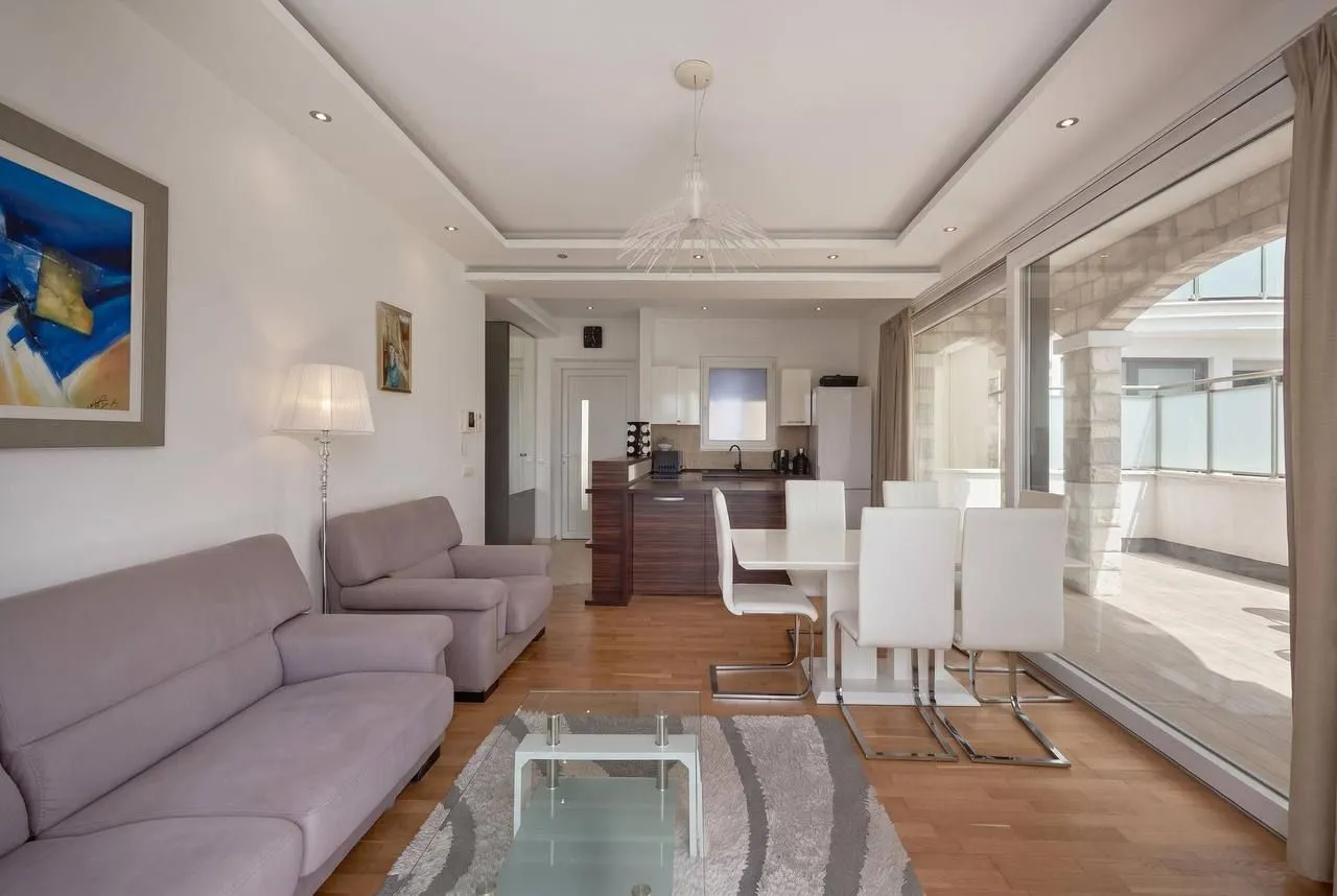 Spacious living room connected to the dining area and kitchen.