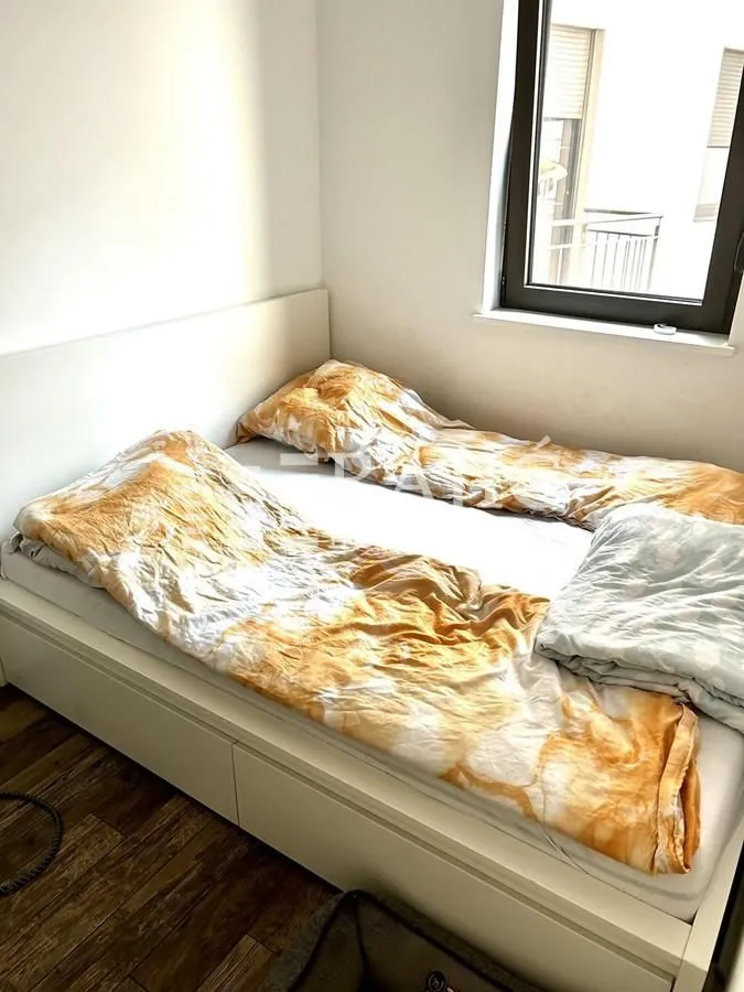 Small bedroom with a double bed and a window.