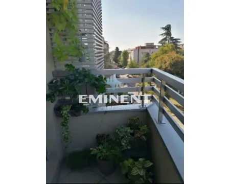 Small balcony with decorative plants and a metal railing. - image 12