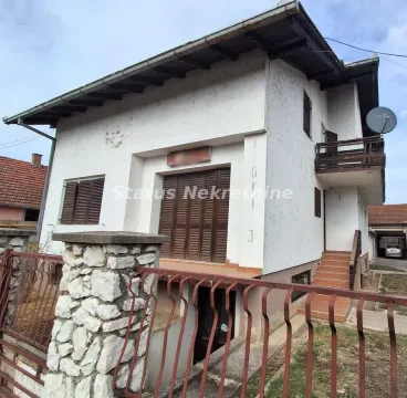 View of the exterior of the house with a yard and fence. - image 2