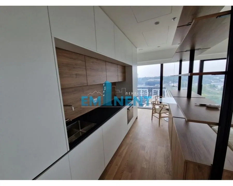 Modern kitchen with white and wooden cabinetry and a built-in sink.