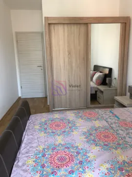 Bedroom with a large double bed and a wooden wardrobe with a mirror. - image 19