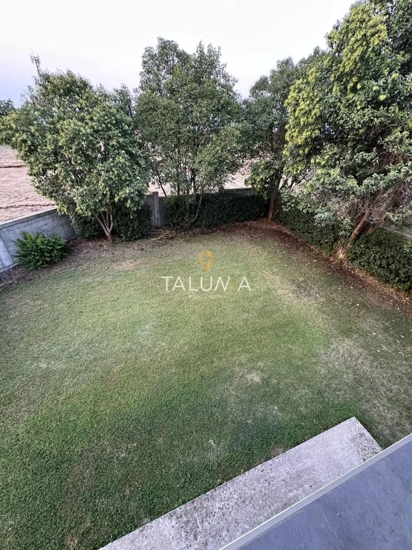 View of the landscaped courtyard with lawn and greenery.