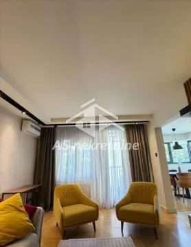Living room with armchairs and a view of windows with curtains. - image 4