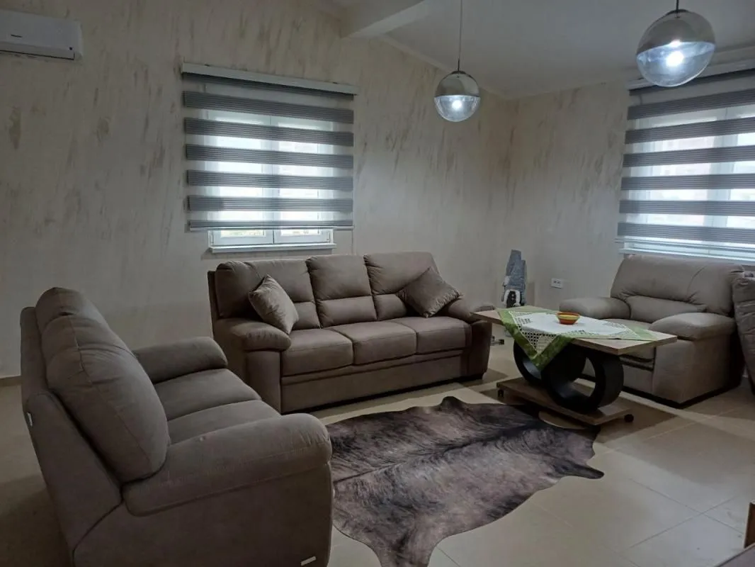 Living room furnished with a sofa set and a coffee table.