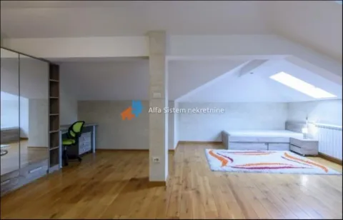 Attic bedroom with a bed, desk, and large wardrobe. - image 12