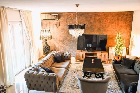Spacious living room with seating set, TV, and decorative wall. - image 5