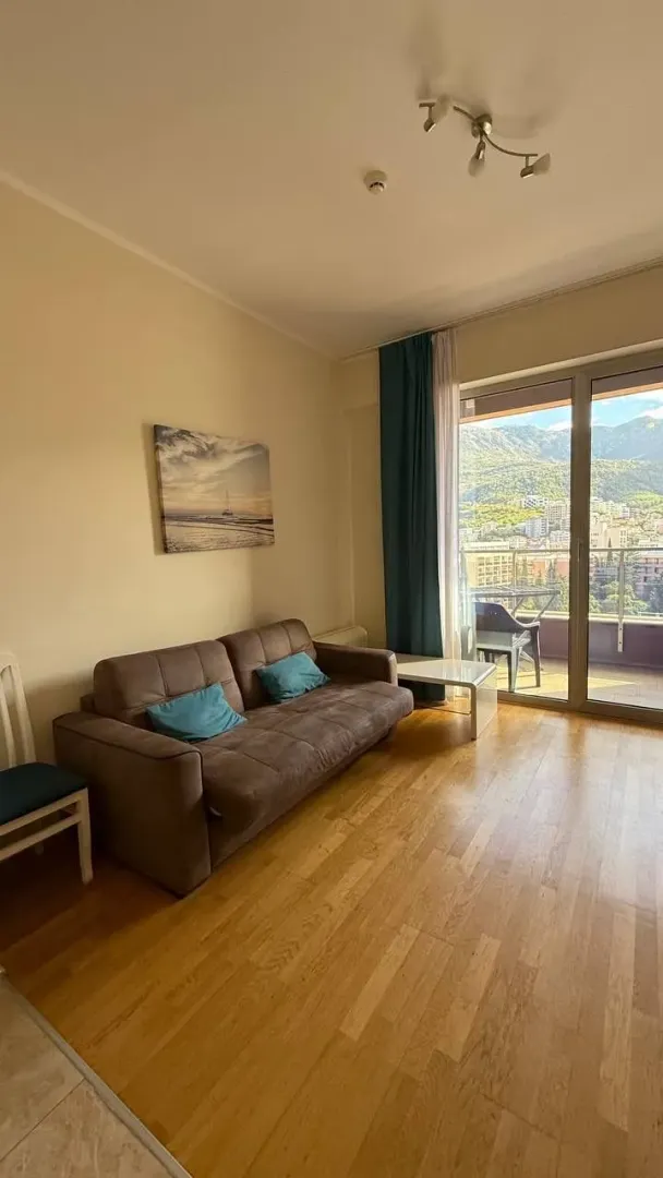 Living room with a sofa and access to the terrace.
