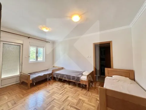 Bedroom with three wooden beds and parquet flooring. - image 5