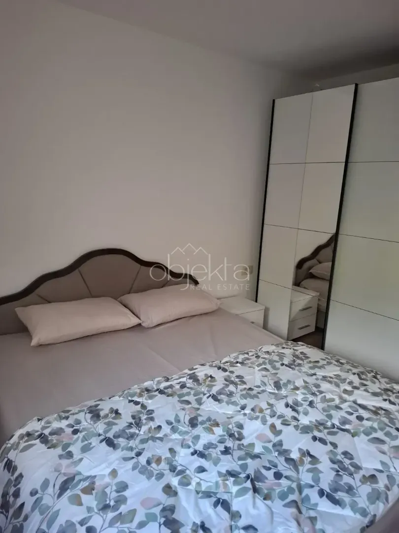 Bedroom with a double bed and a mirrored wardrobe.