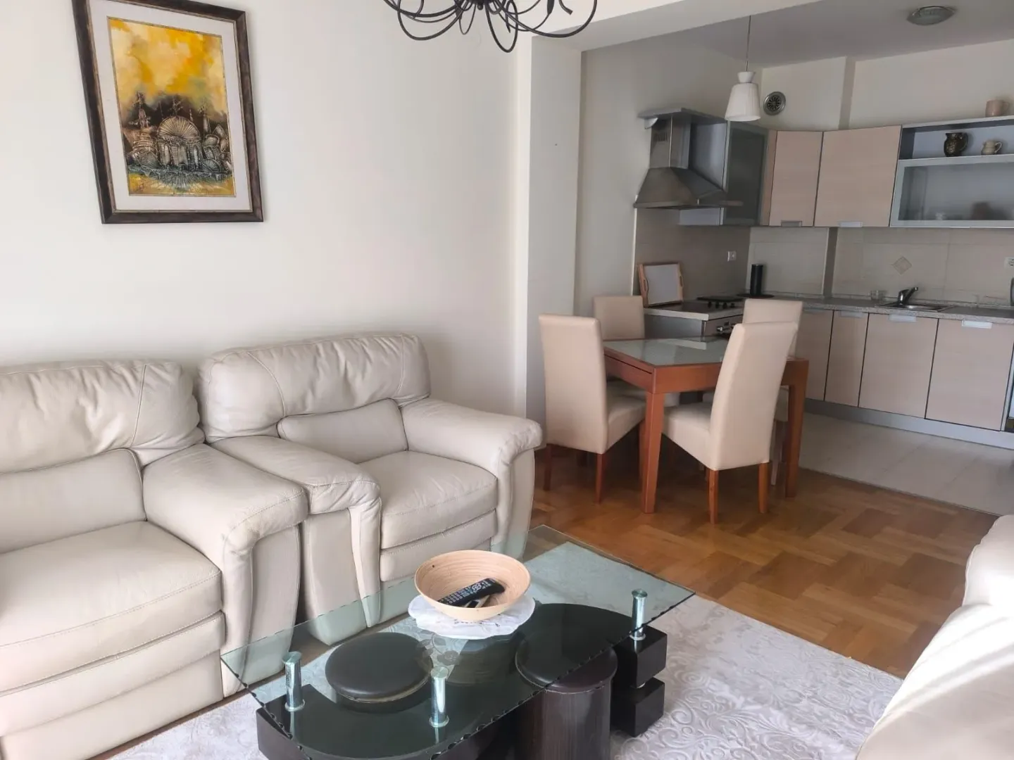 Spacious living room with a sofa set and a view of the dining area and kitchen.