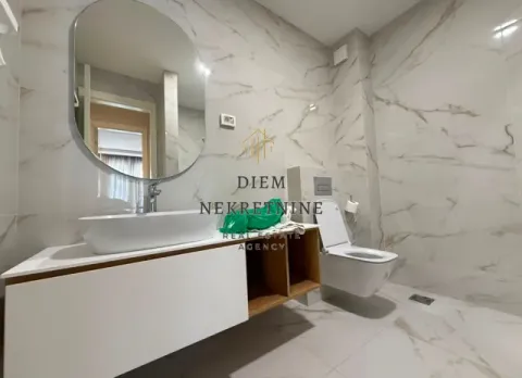 Modernly equipped bathroom with a washbasin, mirror, and toilet. - image 16