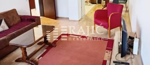 Living room with sofa, armchair, and television. - image 4