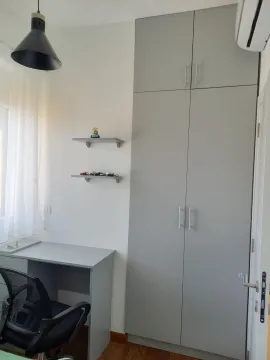 Small bedroom with a built-in wardrobe, desk, and shelves. - image 15