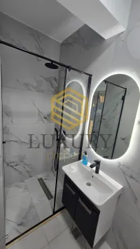 Modern bathroom with a walk-in shower and a vanity. - image 17