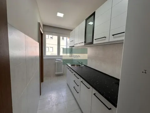 Small kitchen with white cabinets and a dark countertop. - image 4