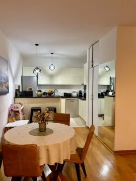 Dining area with a table and chairs and a view of the kitchen. - image 8