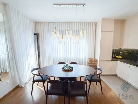 Dining area with a round table and chairs next to the kitchen. - image 5