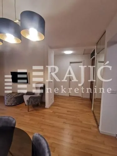 Living room with a seating set and a dining table.