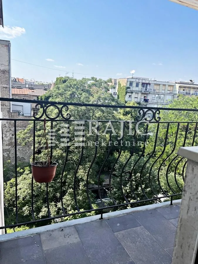 View from the terrace overlooking surrounding buildings and greenery.
