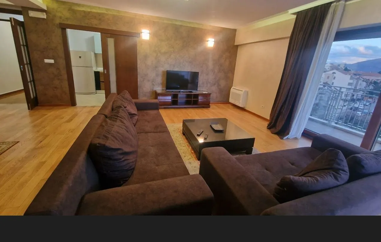 Spacious living room with a seating set and terrace access.