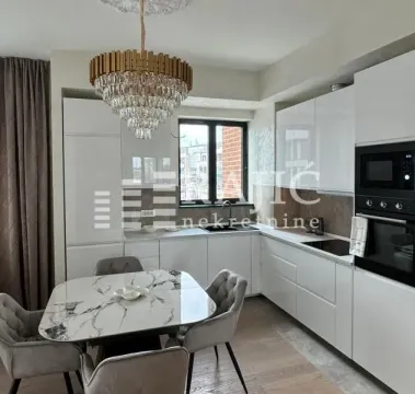 Modern kitchen with dining area and built-in appliances. - image 5