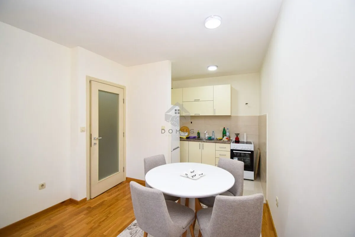 Small kitchen with a dining table and four chairs.