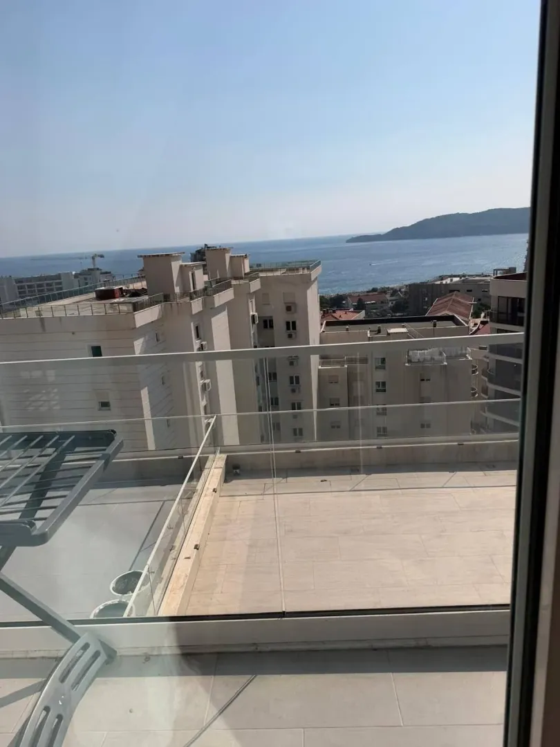 View from the terrace overlooking surrounding buildings and the sea.