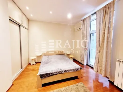 Furnished bedroom with a double bed, built-in wardrobe, and access to the terrace. - image 6