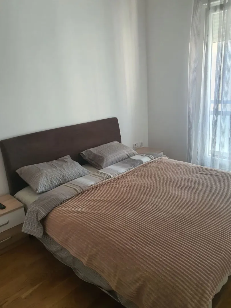 Furnished bedroom with a double bed.