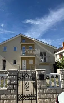 Exterior of a three-story house with a fenced yard. - image 2