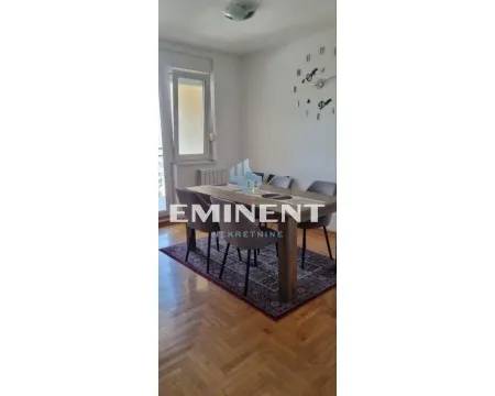 Dining area with a table, chairs, and parquet flooring. - image 3