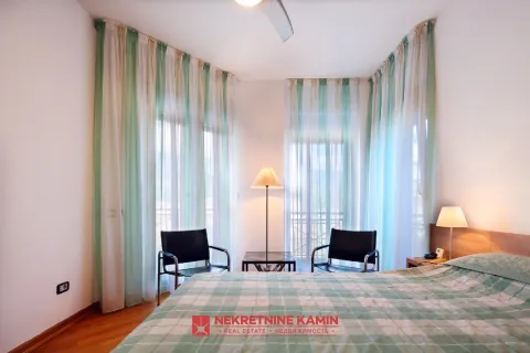 Furnished bedroom with a double bed, armchairs, and large windows with light curtains. - image 14