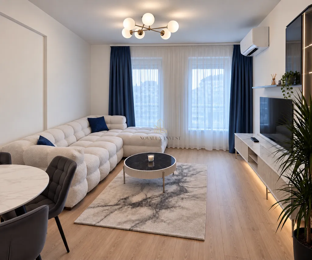 Modern and bright living room with a sofa, TV, and dining table.