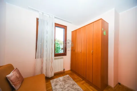 Smaller bedroom with a bed, wooden wardrobe and a window. - image 12
