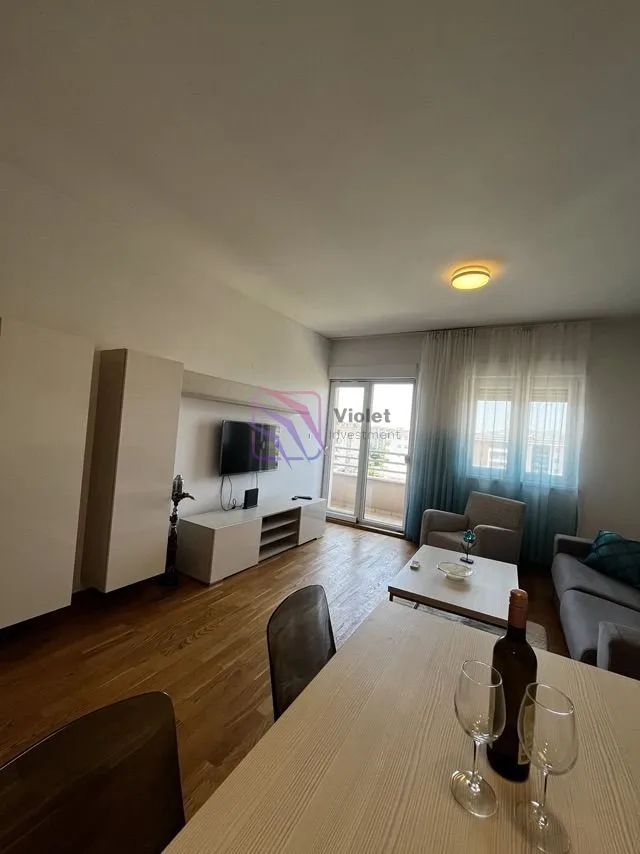 Living room with a dining area, sofa set, and access to the terrace.