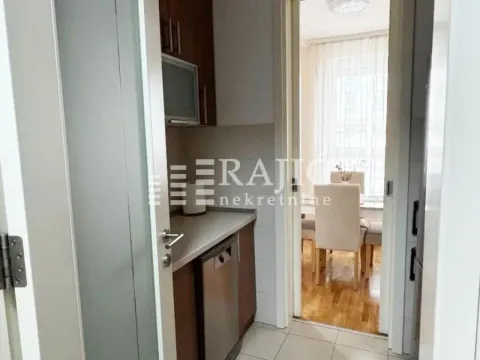 View from the hallway towards the kitchen and dining area. - image 6