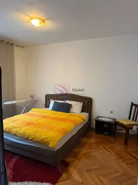 Spavaća soba sa bračnim krevetom, noćnim stočićem i drvenim podom. - image 16
