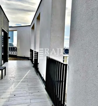 Spacious terrace with modern railing and city view. - image 13
