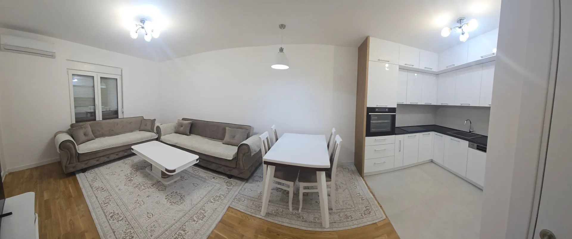 Spacious living room with an open-plan dining area and kitchen.