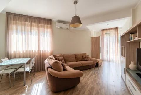Svijetla dnevna soba sa ugaonom garniturom, trpezarijskim stolom i modernim osvjetljenjem. - image 2