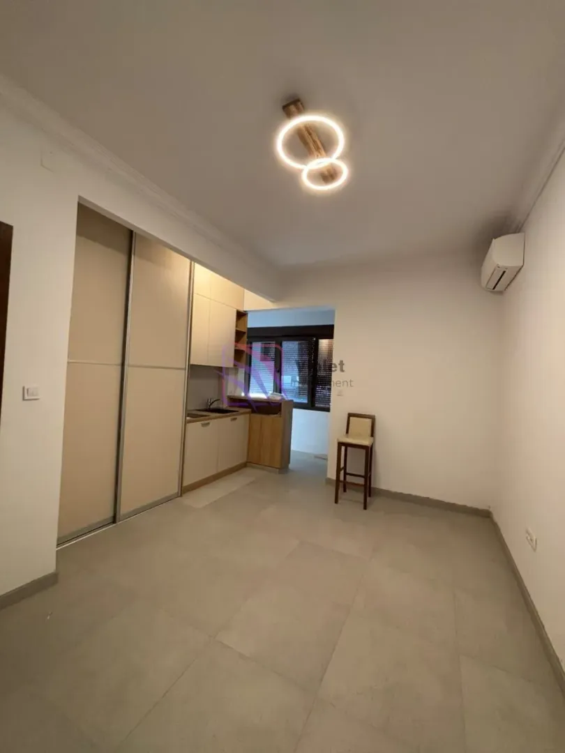 Small kitchen with built-in units and a wardrobe in the extension of the room.