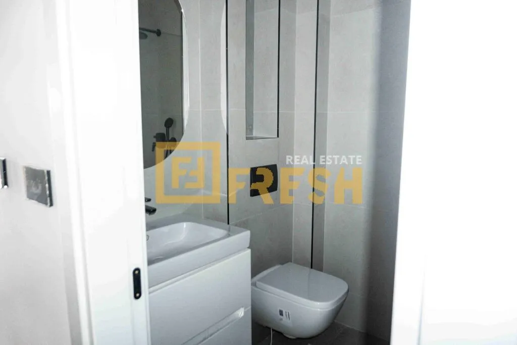 Moderne kupatilo sa umivaonikom i ugradnom wc šoljom.