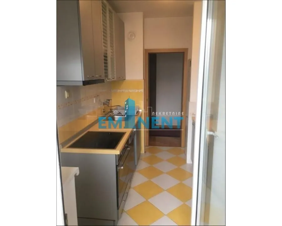 Small kitchen with cabinets and sink.