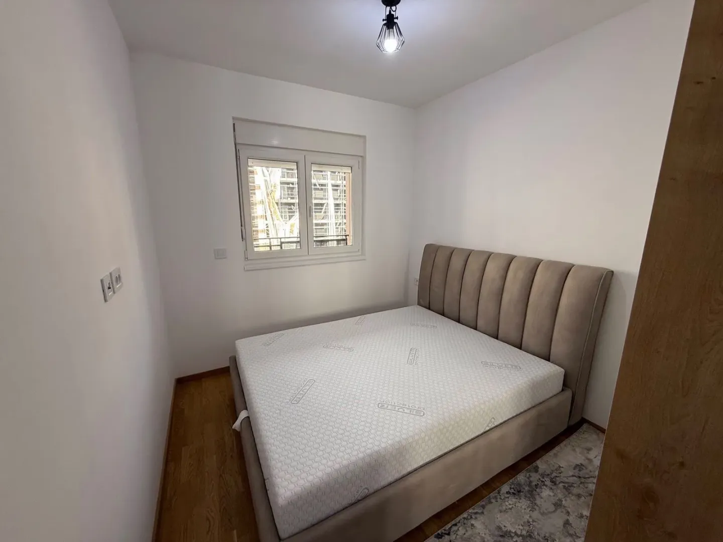 Small bedroom with a double bed and a window.