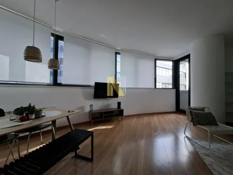 Spacious living room with a dining area and large windows. - image 2